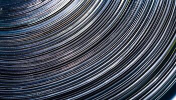 Close-up View of Swirling Metallic Lines Showcasing Intricate Patterns and Reflecting Light in an Abstract Design photo