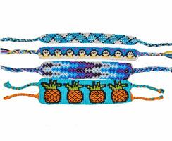 Woven friendship bracelets with blue patterns. Handmade of floss thread, isolated on white background. photo