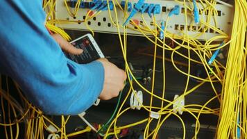 Networking service. network engineer administrator checking server hardware with smartphone equipment of data center video