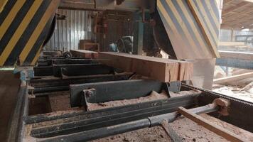 Sawing machine at wood production factory. Timber material processing and cutting at sawmill. Manufacturing process at lumber mill. Automatic Circular Sawing Machine video