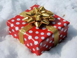 Gift Wrapped In Red And Gold, Sitting On Snow. photo