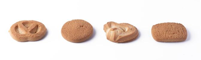 row of four assorted cookies on white background, showcasing different shapes and textures photo