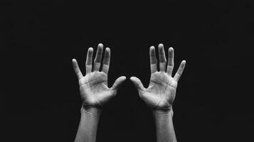 Two hands reaching out against dark background, symbolizing connection and longing. black and white contrast highlights emotional expression and texture of skin photo