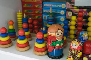 many wooden multi-colored pyramids standing on a shelf photo
