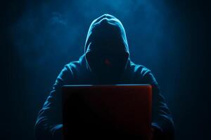 Abstract digital hacker man with a laptop. Male criminal, hoodie and ready for coding, cyber-attack and programming. Cyber hacker attack concept photo