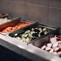 A buffet with vegetables in metal trays photo