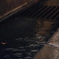 Rain drops on a drain grate photo