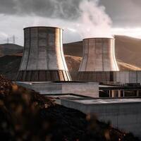 Two cooling towers in a mountain range photo
