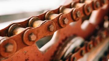Close up of a chain on a metal machine photo