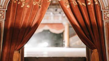 A curtain is open in front of a stage photo