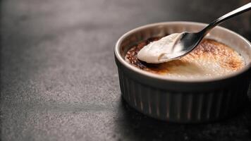 A spoon is in a small cup with cream photo