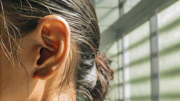 A woman with her ear on the side of her head photo
