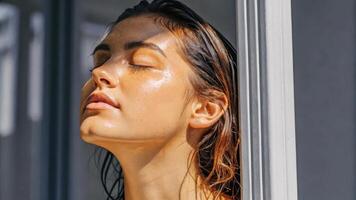 A woman with wet hair standing outside photo