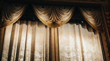 A curtain with a gold curtain and a curtain rod photo