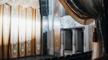 A curtain is seen in front of a theater photo