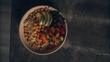 A bowl of food with vegetables and chickpeas photo