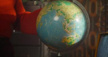 A person holding a globe in front of a computer photo