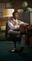 A man sitting in a chair with a book on his lap photo