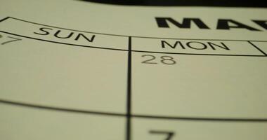 A close up of a calendar with the date of march photo