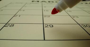 A red marker is pointing to the calendar photo