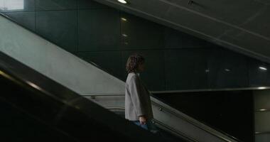 A man walking down an escalator in an empty building photo