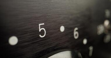 A close up of a black dial with numbers on it photo