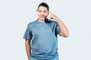 Pensive asian man with doubtful expression isolated. Thoughtful guy looking at camera isolated photo