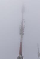 Cell tower in the mountains during fog Poland photo