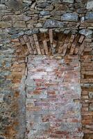 Ancient ruins, an ancient window in an ancient brick wall of a monastery, bricked up.. Komarno, Poland. photo