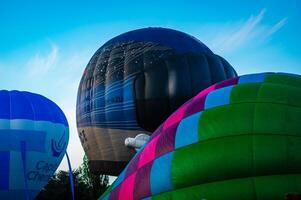 Various hot air balloons inflating photo