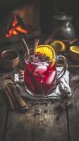 Cozy winter mug of mulled wine with cinnamon and orange slices on rustic table setting photo