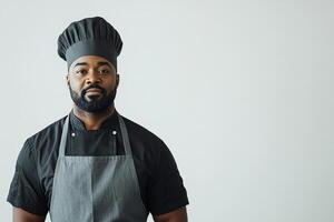 Chef in uniform and apron against neutral background. Copy space photo