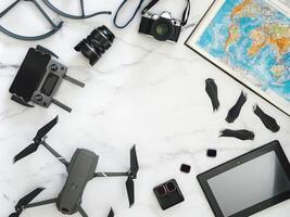 Travel concept with copy space. Drone, camera and map, top view or flat lay photo