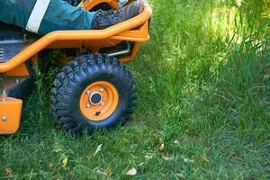 Summer work.Professional grass cutting on lawns with a lawn mower tractor photo