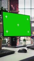 Vertical Green screen PC monitors in empty call center office where unsatisfied customers call to solve technical problems. Mockup computer displays in customer support workspace, panning shot video