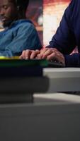 Vertical Call center senior agent dealing with unhappy customers, listening to issues. Experienced Asian customer support worker handling clients complaints in company workspace, camera B video