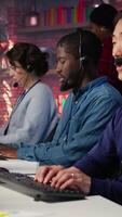 Vertical Customer service agent answer customer questions related to products or services. Call center employee managing incoming and outgoing calls, handling customer complaints, camera B video