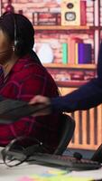 Vertical Call center senior engineer arriving at work, using AI, helping customers regain access to accounts. Customer center technician at desk using artificial intelligence, assisting clients, camera A video