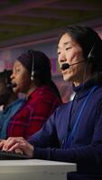 Vertical Call center admin team working together to provide live chat support, handling clients complaints. Teamworking colleagues in office dealing with unsatisfied customers, providing solutions, camera B video