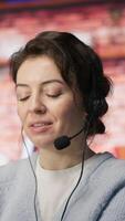 Vertical Customer support employees listening to clients issues. Teamworking call center agents in front of PC in office using headset mic to provide helpful solutions, solving customers concerns, camera A video