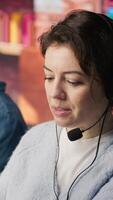 Vertical Customer support workplace coworkers managing incoming and outgoing calls. Teamworking call center agents in front of PC in office using headset mic to answer customers questions, camera A video