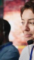 Vertical Customer support workers doing upselling, recommending products to clients during conversation. Call center agents contact prospects to inform them about new services and promotions, camera A close up video
