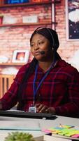 Vertical Call center employee handling customer concerns, doing complaint resolution using AI. Persuasive customer service agents contact clients, doing upselling using artificial intelligence video