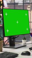 Vertical Chroma key computer displays in empty office showing analytics dashboards and data graphs. Office workspace with green screen PCs showing digital data visualization, panning shot video