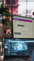 Vertical Call center worker in office using AI chatbot to answer customer questions. Man doing customer service job using artificial intelligence, generating automated responses providing solutions, camera A video