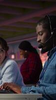 Vertical Call center manager supervising agent providing step by step guidance to customers. Customer center supervisor overseeing work done by employee walking clients through technical solutions, camera B video