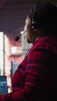 Vertical Call center worker in office using AI chatbot to provide quick replies to common customer queries. Woman doing customer service job generating automated responses to clients using AI, camera B video