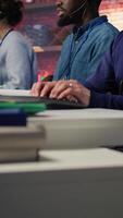 Vertical Call center agent helping customers regain access to accounts, diagnosing problems. Customer center staff member assisting clients needing help, providing accurate information, camera B video