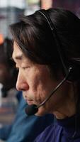 Vertical Team leader overseeing work done by call center agent tracking shipments in office. Customer center manager supervising worker locating clients packages and provide status updates, camera B video