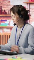 Vertical Worker providing live chat support, typing on keyboard, handling clients complaints. Call center agent dealing with unsatisfied customers, providing helpful solutions to their concerns, camera A video